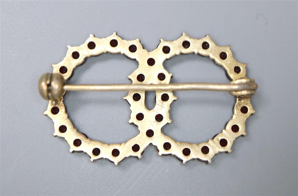 A late Victorian gilt white metal and facet cut garnet set twin sphere brooch, 30mm, gross 3.5 grams.